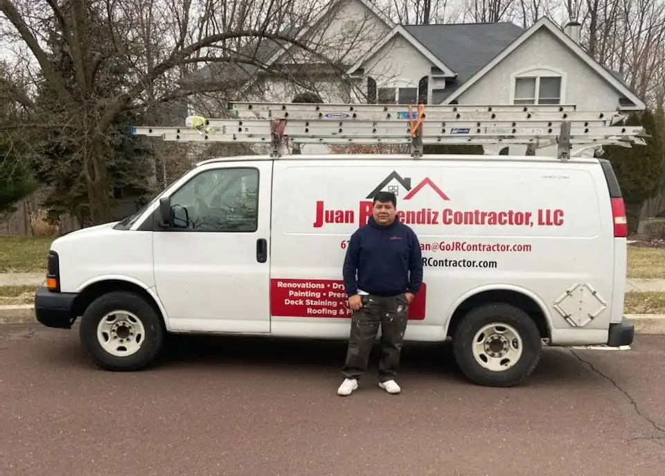 Juan Resendiz standing beside the Juan Resendiz Contractor, LLC work van in Coatesville, Pennsylvania