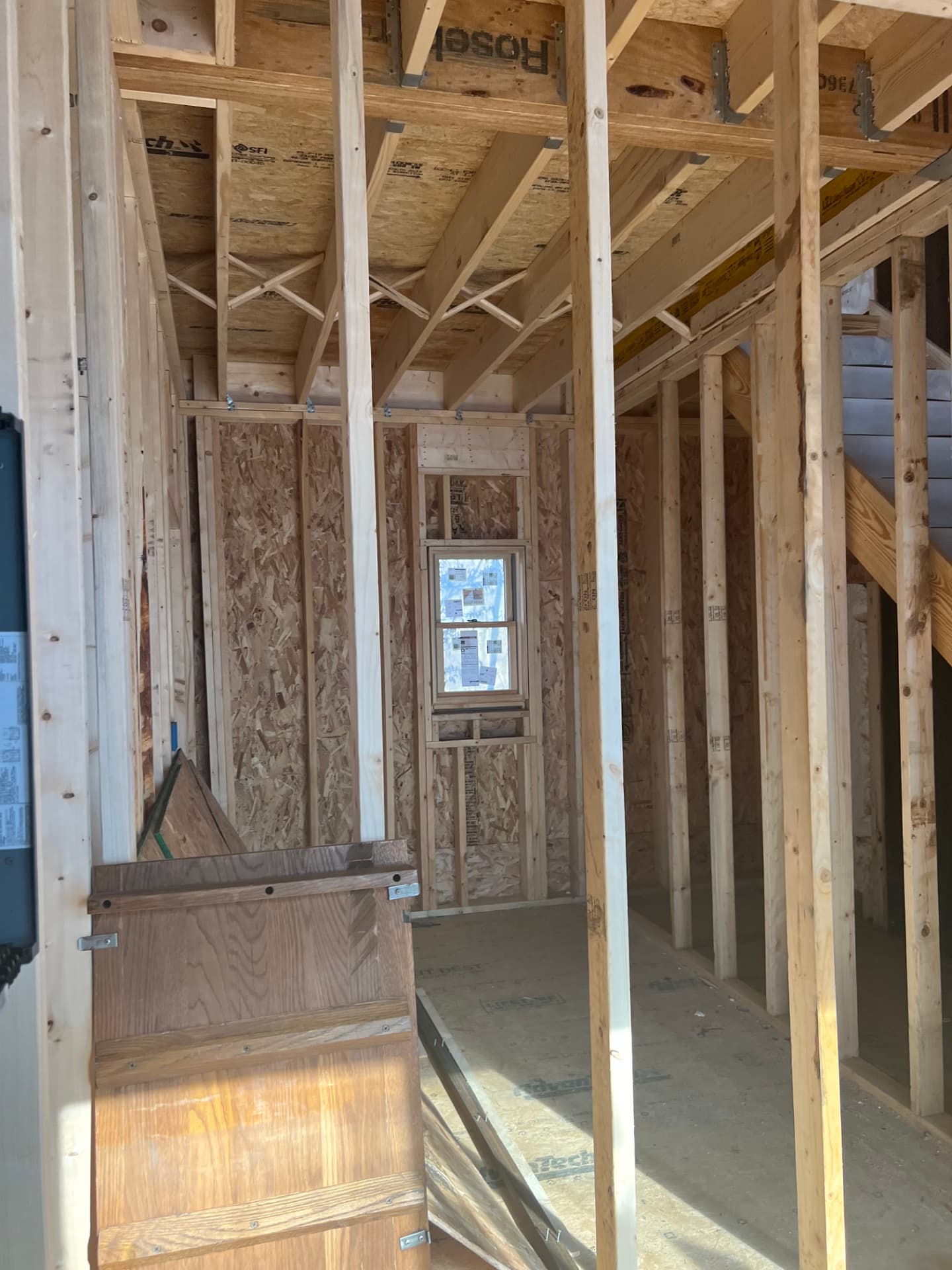 Residential remodeling project showing interior wall and ceiling framing