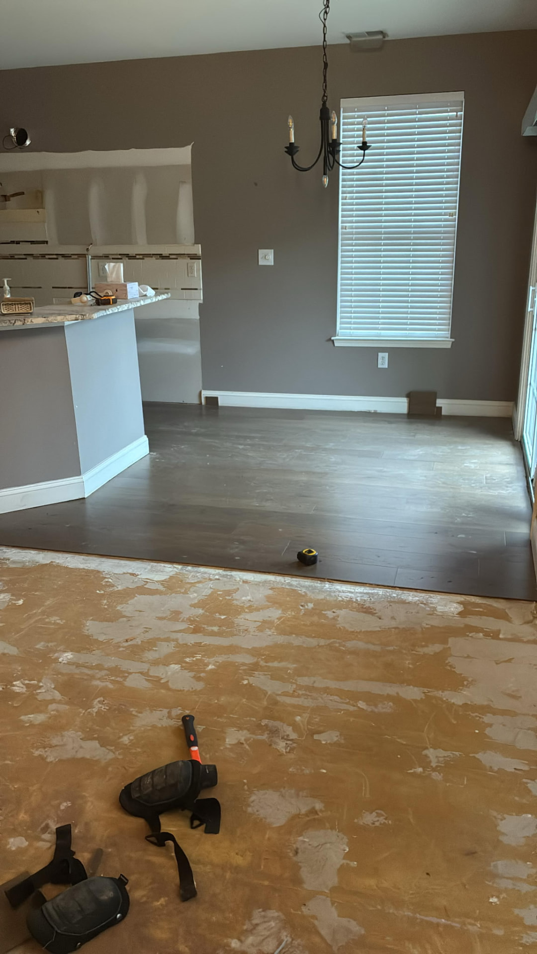 Dark hardwood floor installation in progress during a residential remodel